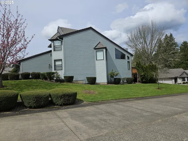 a view of a house with wooden deck and furniture