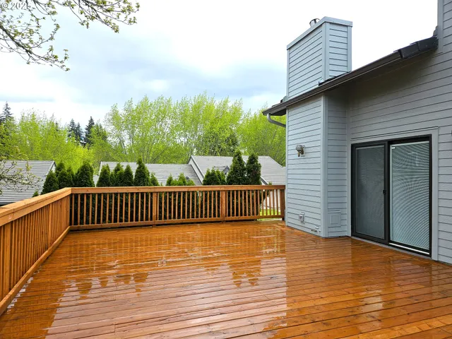 a view of balcony with wooden floor and fence