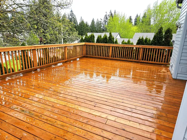 a view of balcony with wooden floor and fence