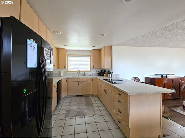 a kitchen with a sink cabinets and appliances