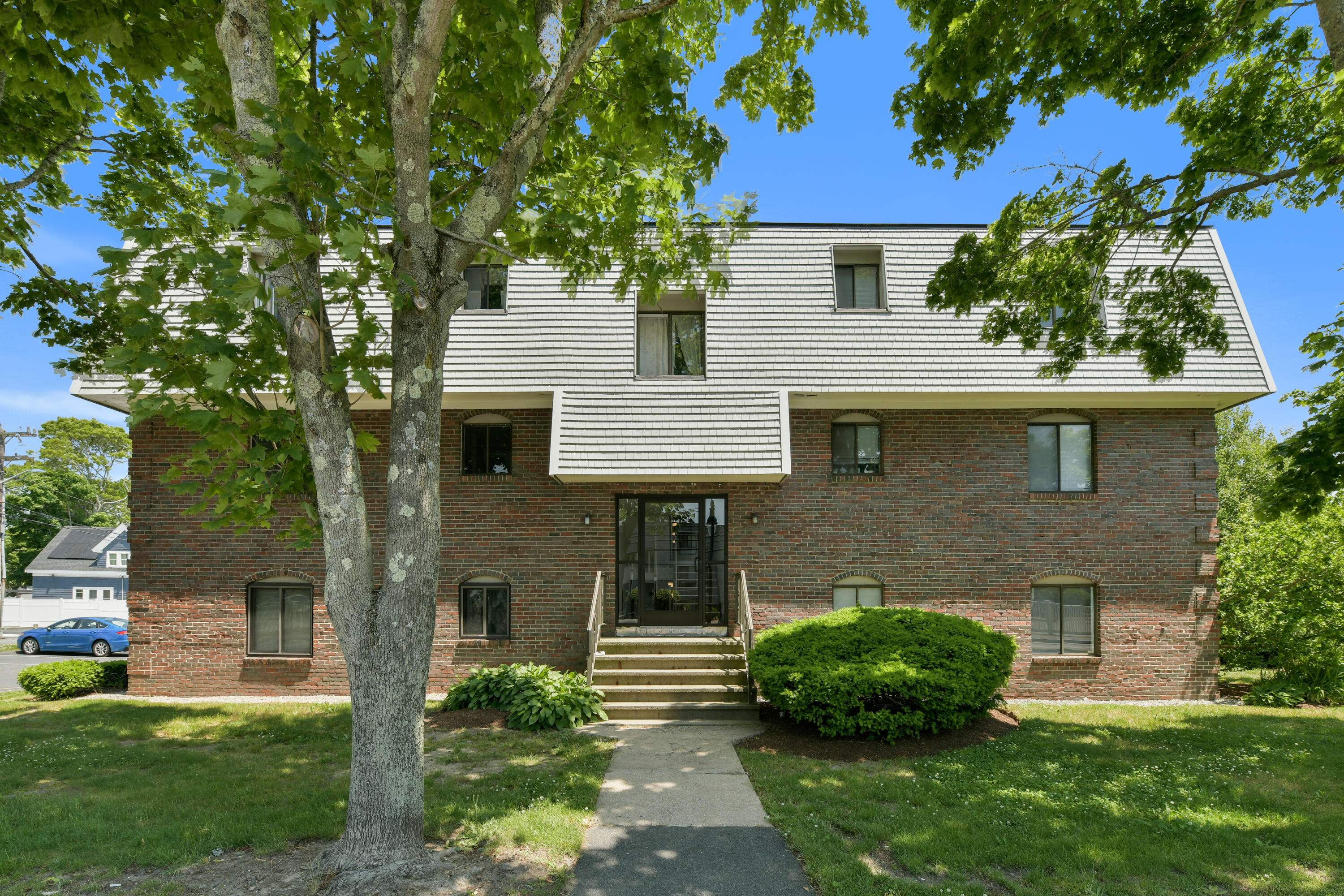 15 Oak Neck Road, Unit 24 Hyannis, MA 02601 - Photo 3 of 17 a front view of a house with a garden