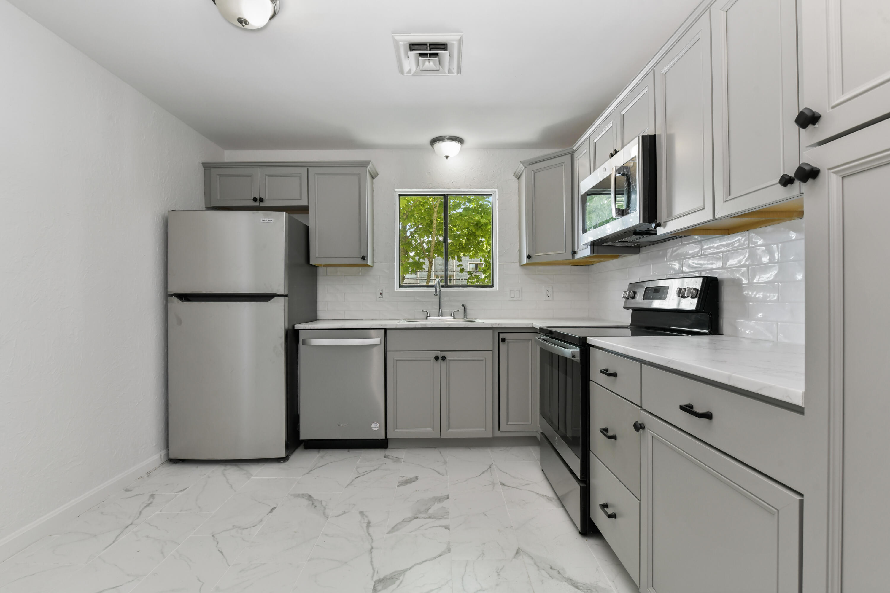 15 Oak Neck Road, Unit 24 Hyannis, MA 02601 - Photo 6 of 17 a kitchen with a refrigerator sink and cabinets