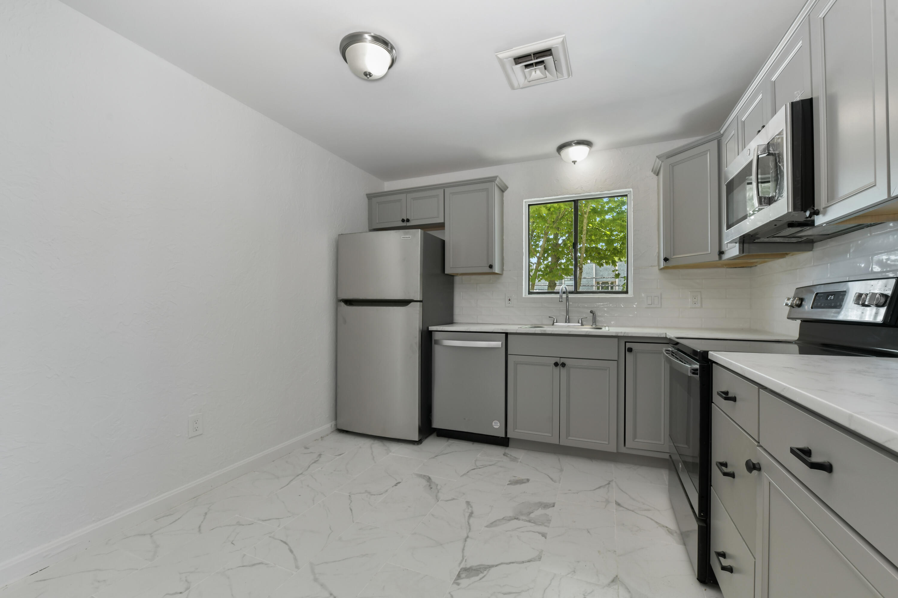 15 Oak Neck Road, Unit 24 Hyannis, MA 02601 - Photo 7 of 17 a kitchen with a refrigerator and a sink