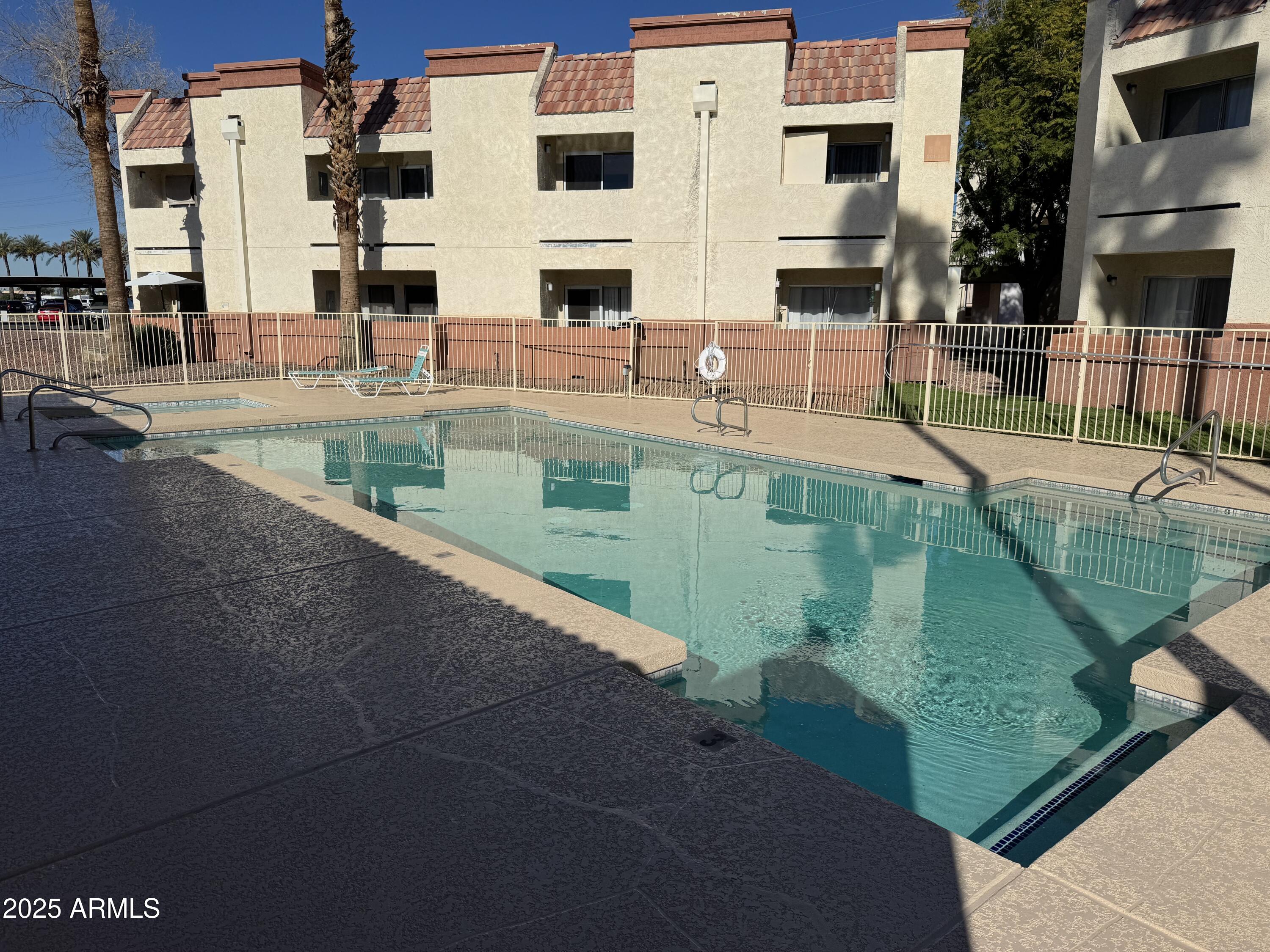 12123 West Bell Road, Unit 164 Surprise, AZ 85378 - Photo 5 of 6 a view of a swimming pool with a house