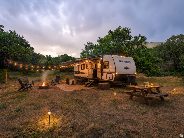 123 West Spring Hollow Road Morgan, UT 84050 - Photo 1 of 13 Recreational vehicle campsite featuring a fire pit, string lighting, and ground lights