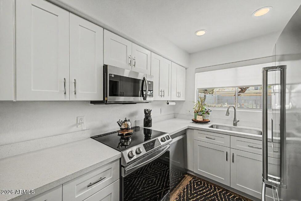 860 North McQueen Road, Unit 1135 Chandler, AZ 85225 - Photo 9 of 24 a kitchen with a sink stove and microwave