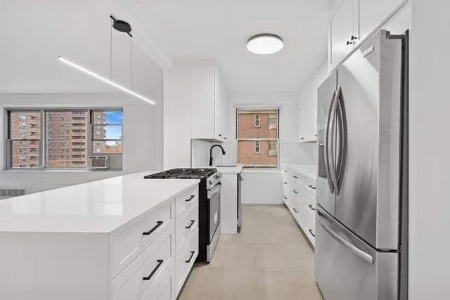 a kitchen with stainless steel appliances a refrigerator sink and stove