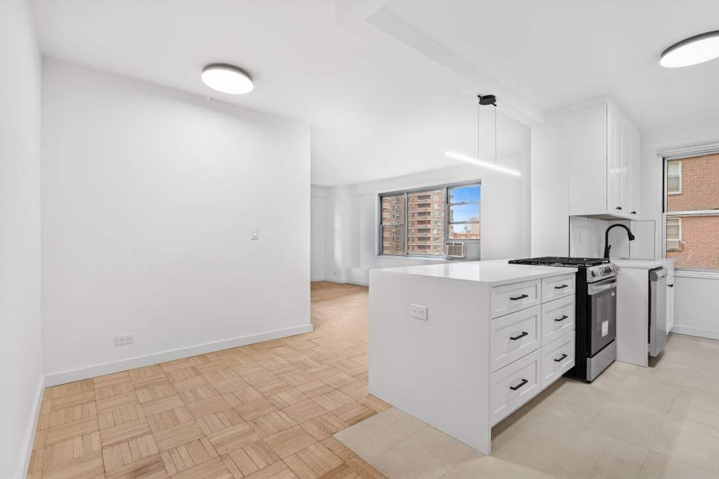 475 FDR Drive, Unit L804 Manhattan, NY 10002 - Photo 12 of 17 a kitchen with white cabinets and sink