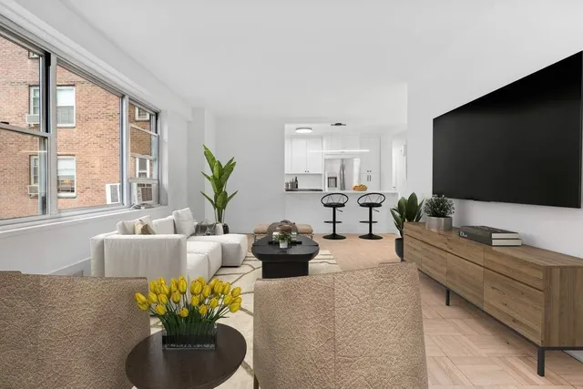 a living room with furniture a flat screen tv and a large window