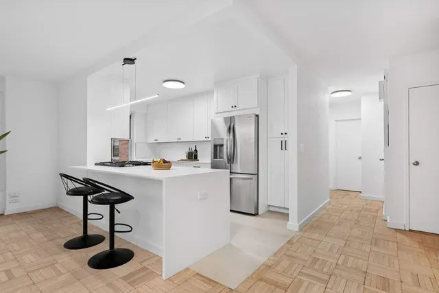 a kitchen with stainless steel appliances granite countertop a refrigerator a sink and a stove