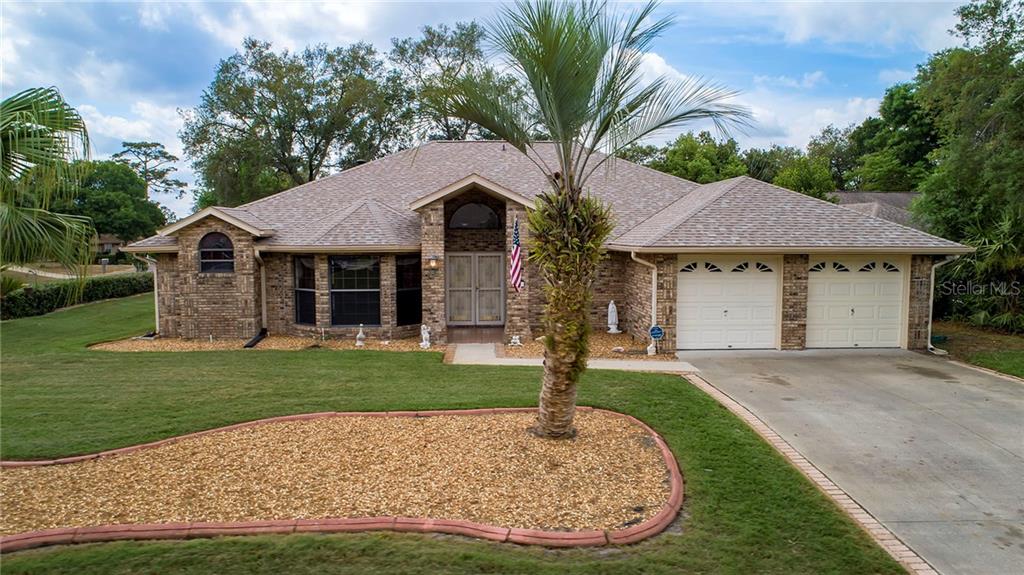 305 Song Bird Road DeBary, FL 32713 - Photo 1 of 1 a front view of a house with a garden and trees
