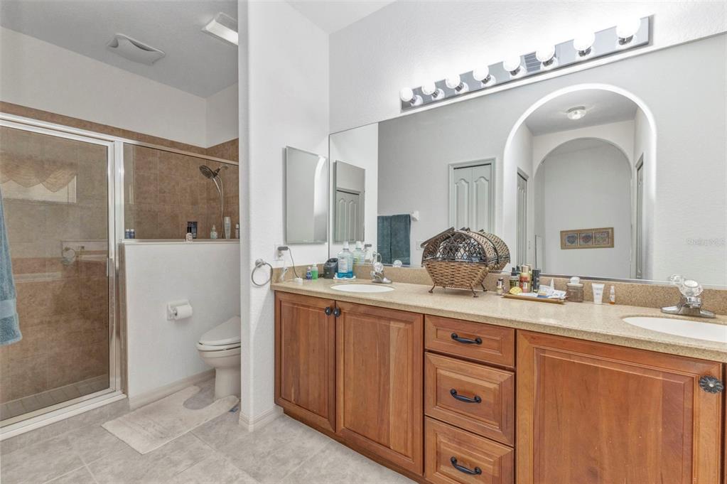24504 Buckingham Way Punta Gorda, FL 33980 - Photo 14 of 42 a bathroom with a granite countertop sink a toilet and a mirror