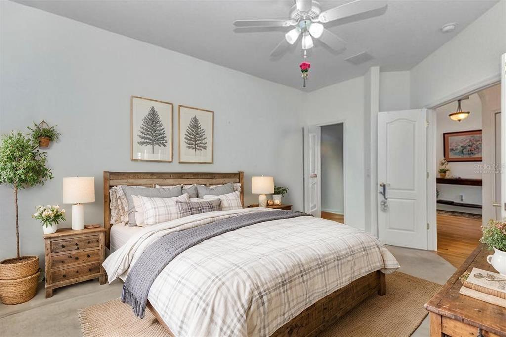 24504 Buckingham Way Punta Gorda, FL 33980 - Photo 18 of 42 a bedroom with a bed and a chandelier