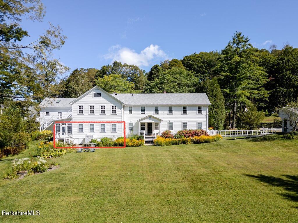 454 Main Road, Unit 2 Monterey, MA 01245 - Photo 1 of 30 a front view of house with yard and swimming pool