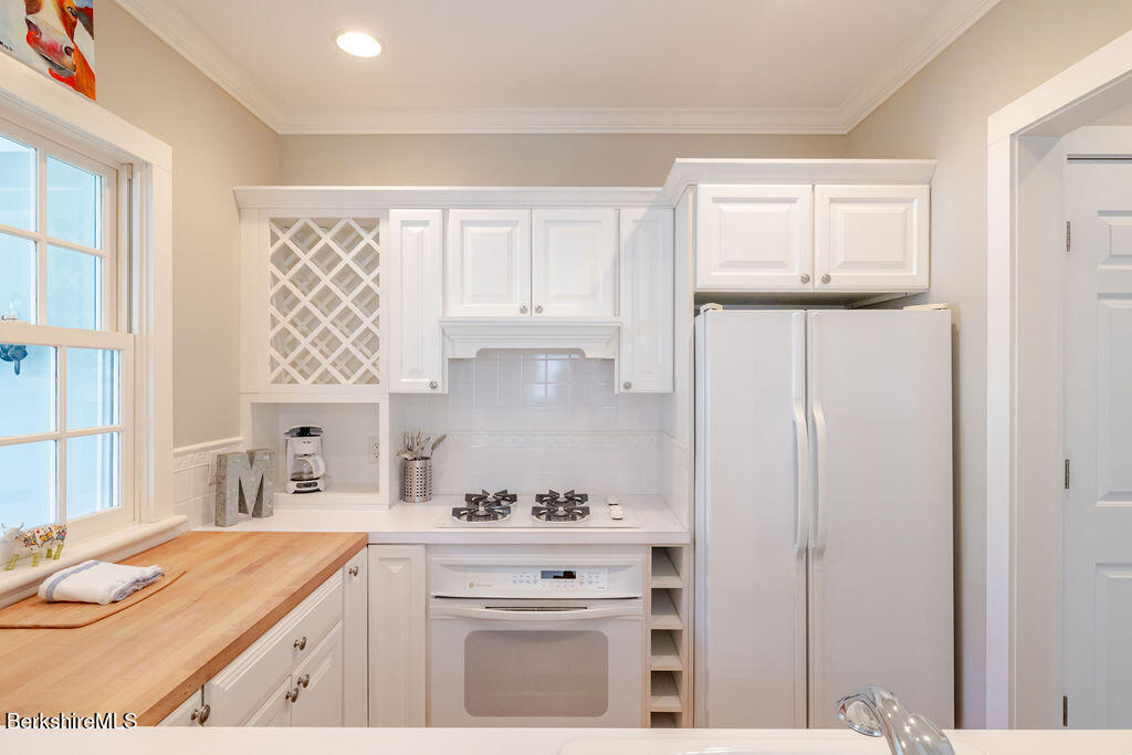 454 Main Road, Unit 2 Monterey, MA 01245 - Photo 18 of 30 a kitchen with granite countertop white cabinets and white appliances