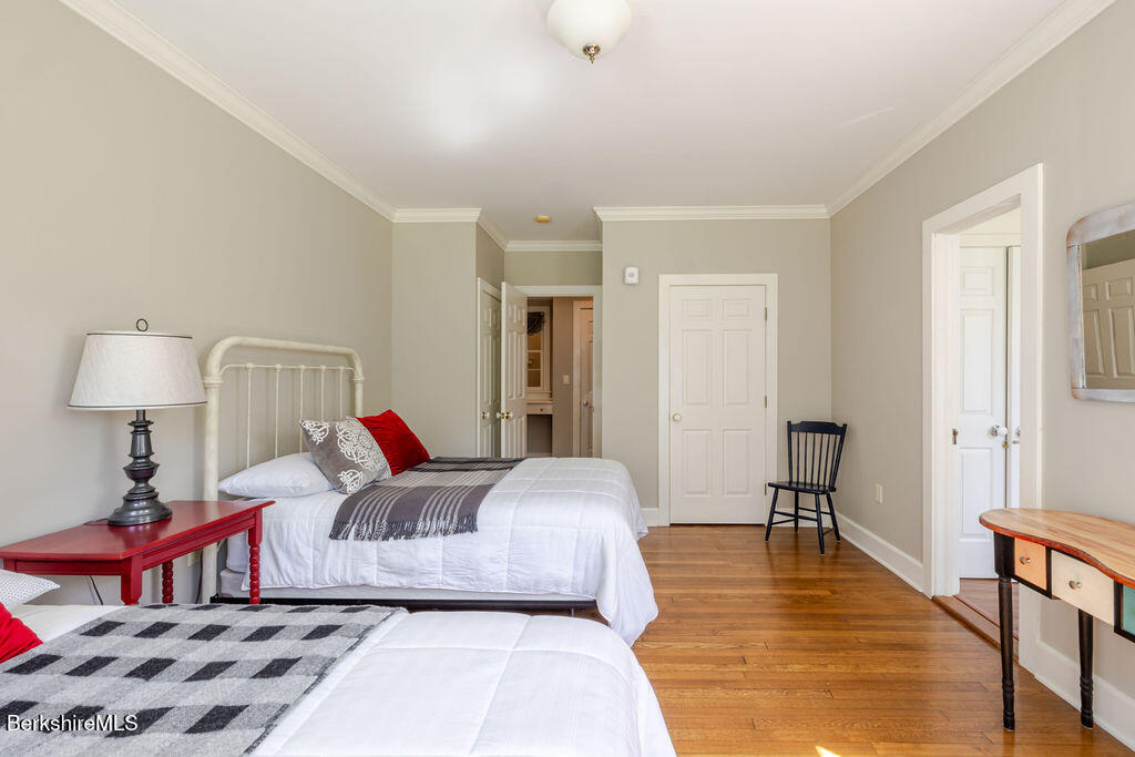 454 Main Road, Unit 2 Monterey, MA 01245 - Photo 22 of 30 a bedroom with a bed and a lamp