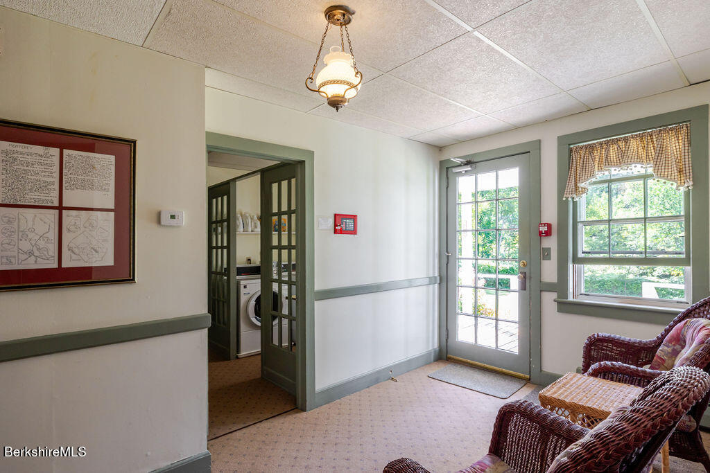 454 Main Road, Unit 2 Monterey, MA 01245 - Photo 27 of 30 a living room with furniture a window and a chandelier