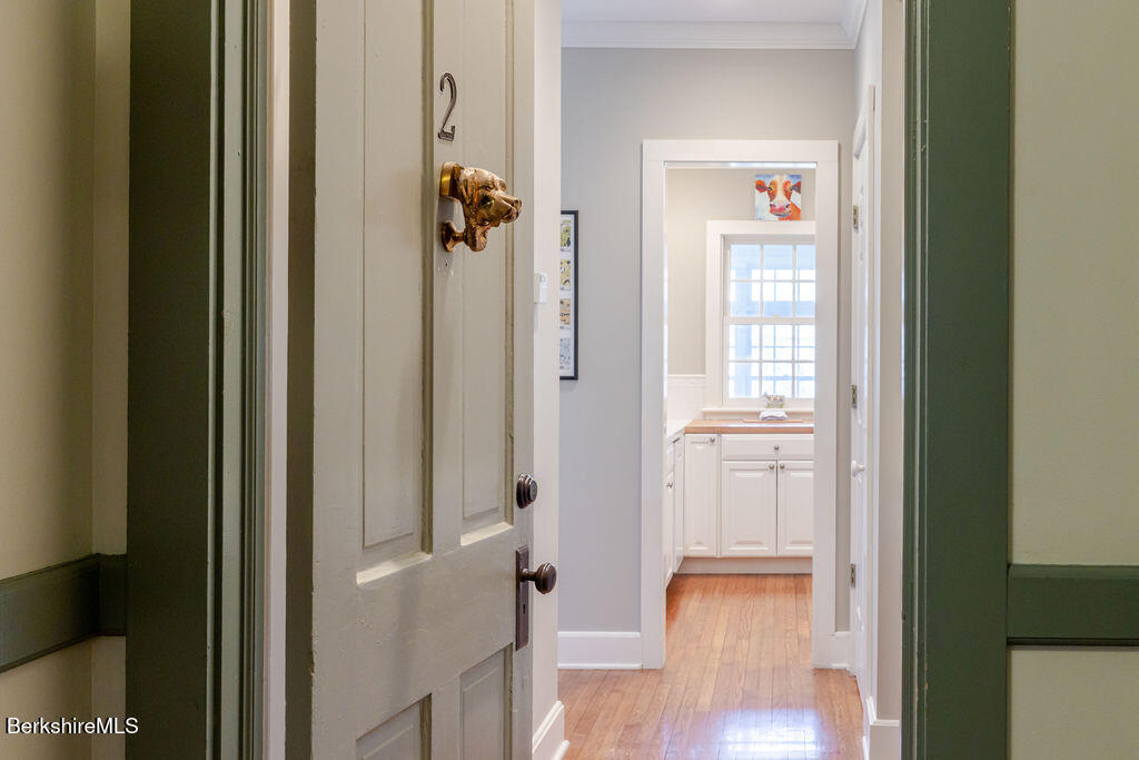 454 Main Road, Unit 2 Monterey, MA 01245 - Photo 7 of 30 a view of a hallway with wooden floor and closet area