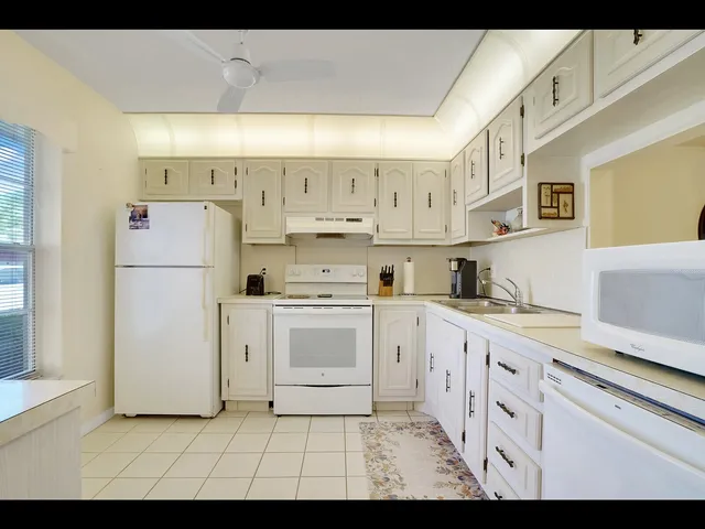 a kitchen with cabinets oven and a sink