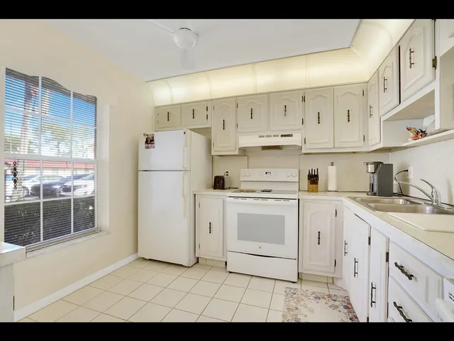 a kitchen with cabinets oven and a sink