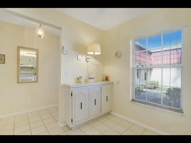 a view of bathroom with mirror and window