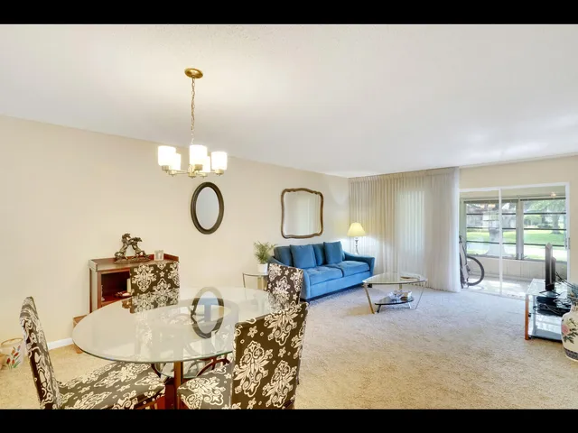 a living room with furniture a table and chairs