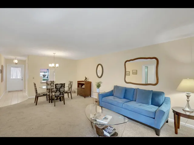 a living room with furniture and a dining table