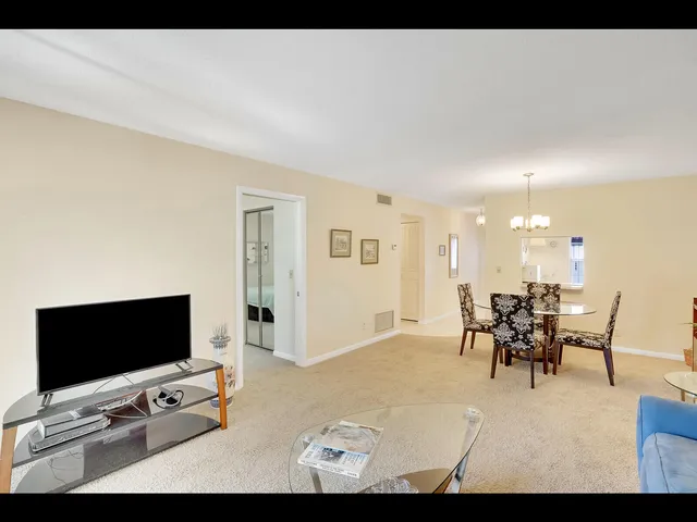 a view of a livingroom with furniture and a flat screen tv