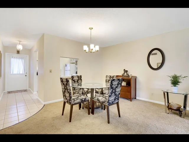 a view of a dining room with furniture and chandelier fan