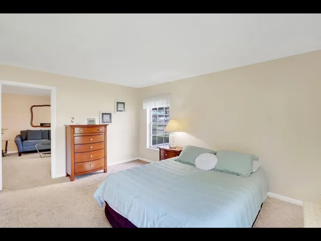 a bedroom with a bed and dresser