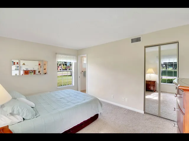 a bedroom with a bed and a view of kitchen