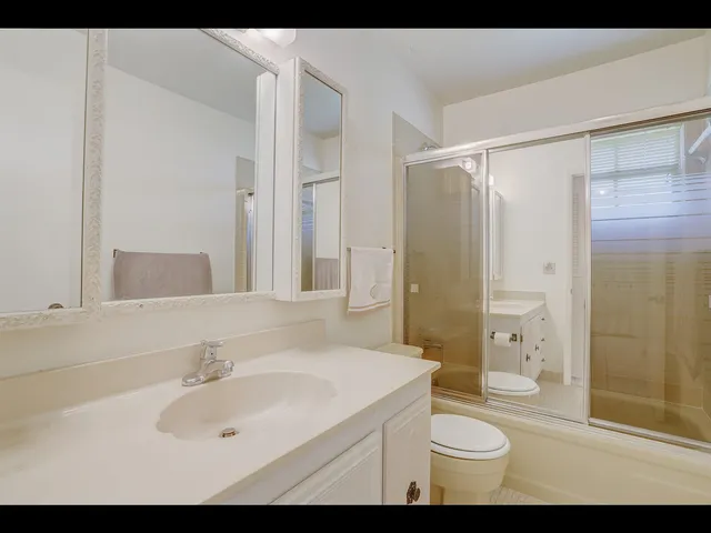 a bathroom with a sink toilet a shower and a mirror