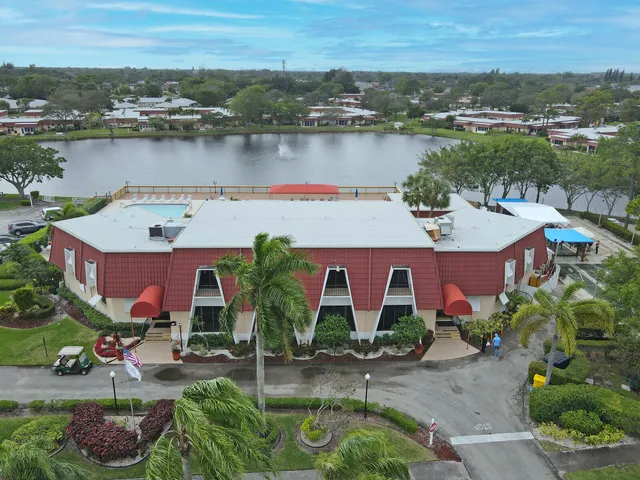an aerial view of house with yard and lake view