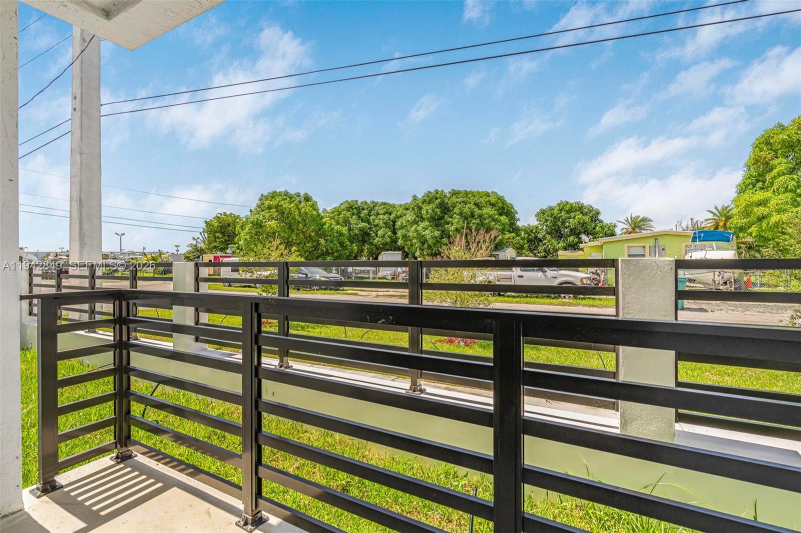 16955 Southwest 100th Avenue, Unit 9 Miami, FL 33157 - Photo 13 of 17 a view of a street from a balcony