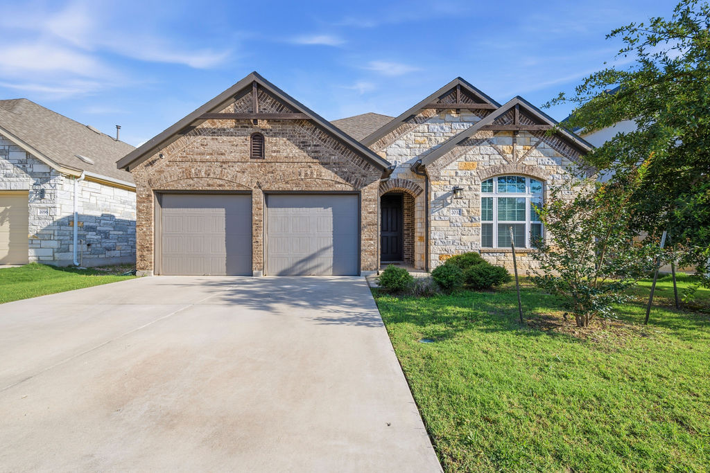Stone and brick facade with gabled roof lines
