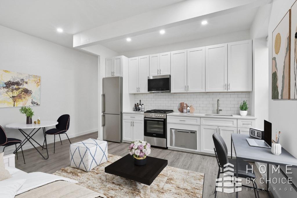 201 West 109th Street, Unit 6C Manhattan, NY 10025 - Photo 2 of 6 a kitchen with a dining table and appliances