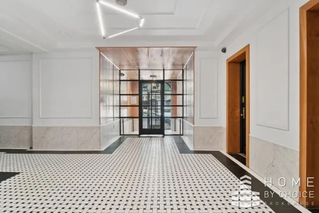 a view of a room with wooden floor and a window
