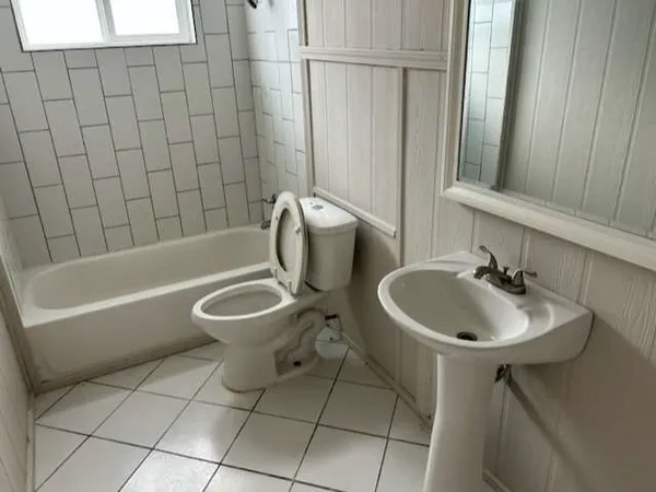 a bathroom with a sink a toilet and a bathtub