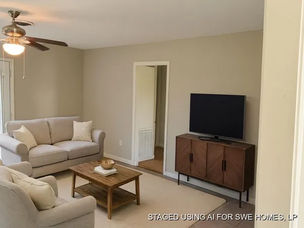 a living room with furniture and a flat screen tv
