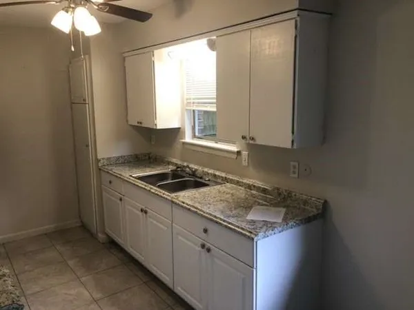 a kitchen that has a sink and a stove in it