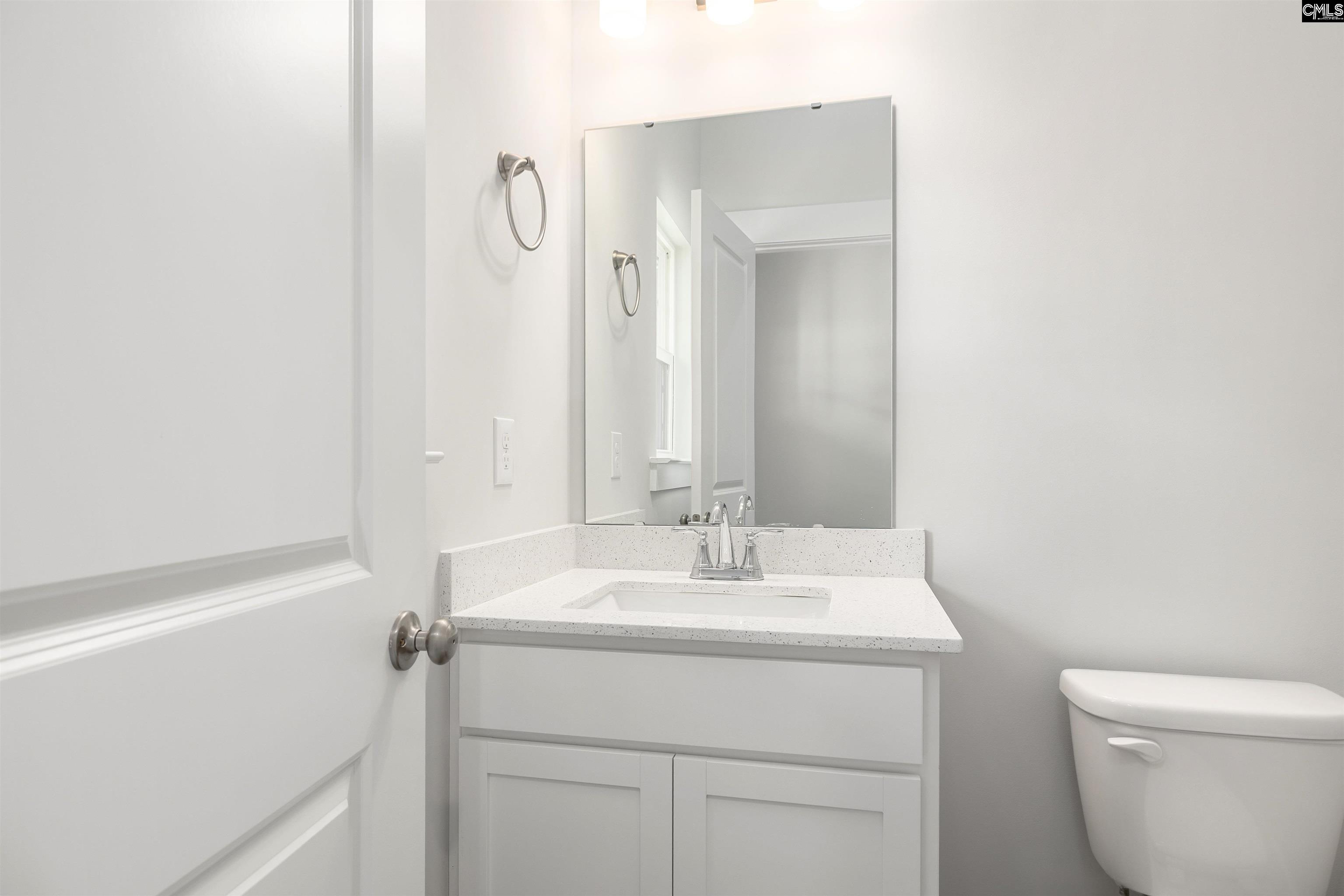 32 Fawn Spot Court Elgin, SC 29045 - Photo 5 of 28 a bathroom with a sink a toilet and a mirror