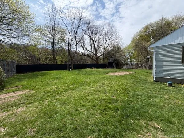 a view of a backyard with a large tree