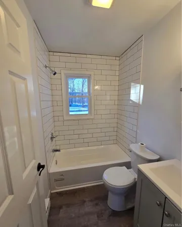 a bathroom with a toilet a sink and bathtub