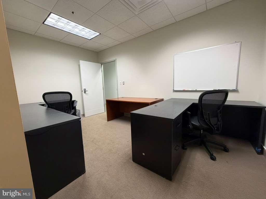 1984 Isaac Newton Square West, Unit 214 Reston, VA 20190 - Photo 3 of 8 a room with a desk and a chair