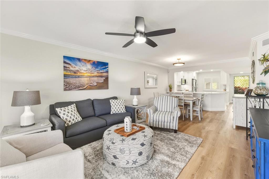 7772 Emerald Circle, Unit 101 Naples, FL 34109 - Photo 14 of 37 a living room with furniture and a view of dining room
