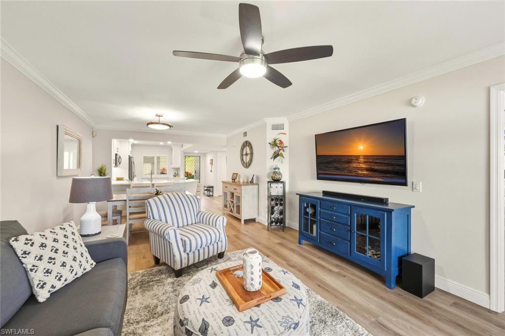 7772 Emerald Circle, Unit 101 Naples, FL 34109 - Photo 15 of 37 a living room with furniture and a flat screen tv