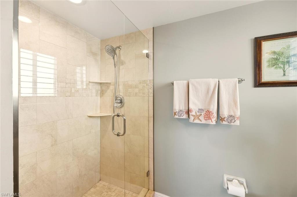 7772 Emerald Circle, Unit 101 Naples, FL 34109 - Photo 19 of 37 a bathroom with a shower and a sink