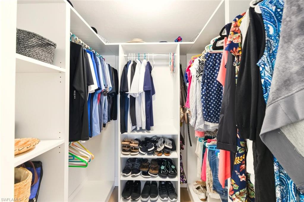 7772 Emerald Circle, Unit 101 Naples, FL 34109 - Photo 20 of 37 a view of walk in closet with clothes and shoes