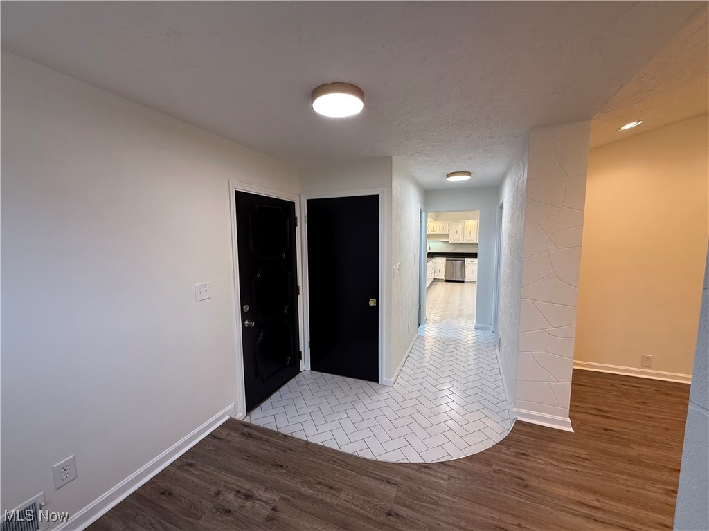 522 North 3rd Street Toronto, OH 43964 - Photo 16 of 47 Corridor featuring wood finished floors, a textured ceiling, and recessed lighting