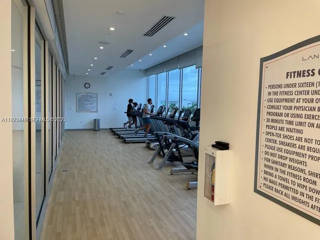 a view of kitchen island with stainless steel appliances wooden floor